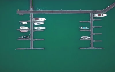 Boats moored at marina dock — ship parking management