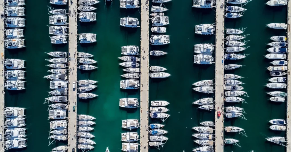 Aerial view of a marina with boats moored in berths alongside empty slips
