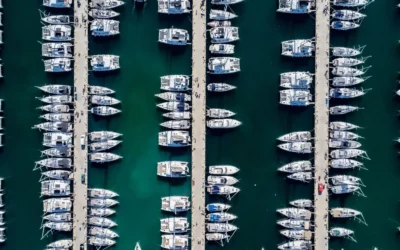 Aerial view of a marina with boats moored in berths alongside empty slips