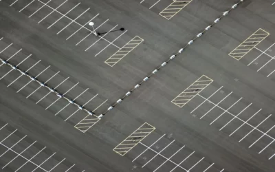 Top-down view of an empty outdoor parking lot with clearly marked spaces