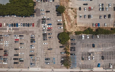 Aerial view of an outdoor parking lot with occupied and empty spaces